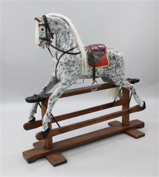 An Edwardian trestle base painted rocking horse, L.4ft 8in.